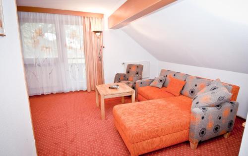 a living room with a couch and a table at Aparthotel Grabner in Bad Füssing