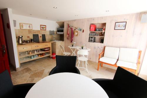 a kitchen with a table and chairs in a room at Domaine du Port Sainte Marie in Maizières-lès-Vic