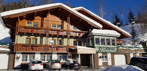 a large building with cars parked in front of it at Pension Kristall in Schladming