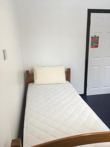 a bed in a room with a white mattress at Ledgowan Bunkhouse in Achnasheen