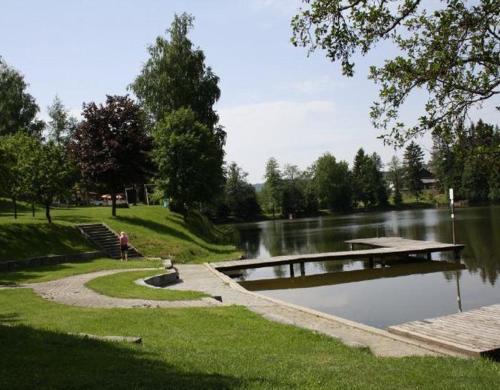 a person sitting on the steps by a river at Mobilheime in Klaffer am Hochficht