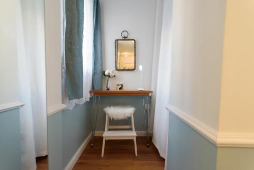 a small dressing room with a chair and a mirror at Marcel Zadar City Center in Zadar