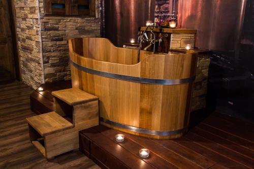 a wooden bath tub in a room with stairs at Luxusni Apartmany Stodolni in Ostrava
