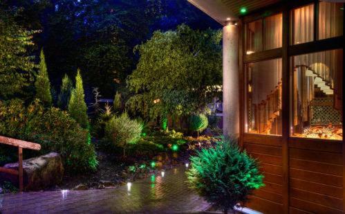 a garden with green lights in a building at Kurpark Flair Hotel Im Ilsetal in Ilsenburg
