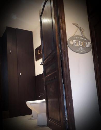 a bathroom with a toilet and a door with a welcome sign at Villa Azur Cap d'Ail in Cap d'Ail