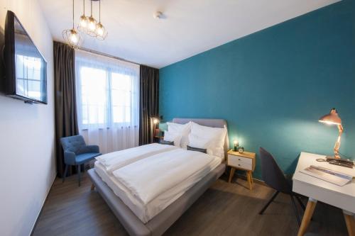 a hotel room with a bed and a desk and a bed sidx sidx sidx sidx at Hotel Memories OldTown in Budapest