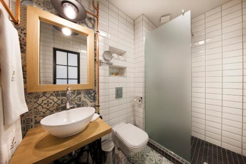 a bathroom with a sink and a toilet at Hotel Memories OldTown in Budapest