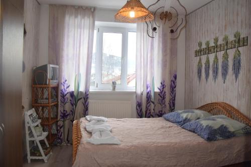 a bedroom with a bed with towels on it at Kvitkovyi Rai З червня басейн з підігрівом 10 на 5 метрів in Slavske