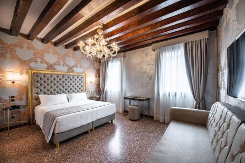 a bedroom with a bed and a chandelier at Palazzo San Lorenzo in Venice