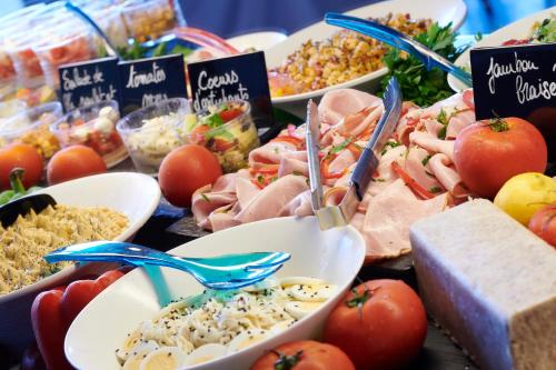 a table filled with different types of food at Hotel Club Le Plein Sud Vacances Bleues in Hyères