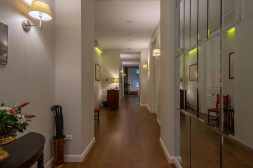 a hallway of a home with white walls and wood floors at TIFLIS OPERA Aparthotel in Tbilisi City