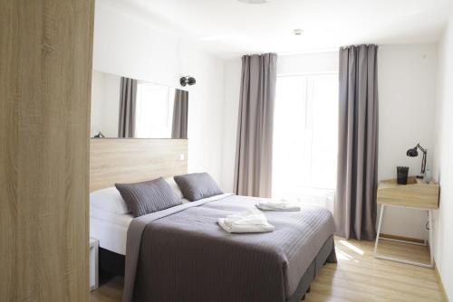 Postel nebo postele na pokoji v ubytování Idylla Apartamenty Polanki