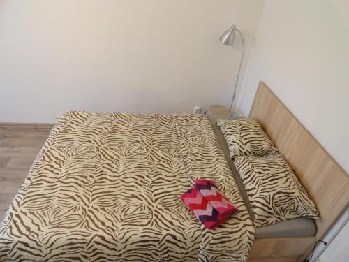 a bed in a room with a zebra print sheets at Apartment Arena Riga quiet center FREE PARKING in Rīga