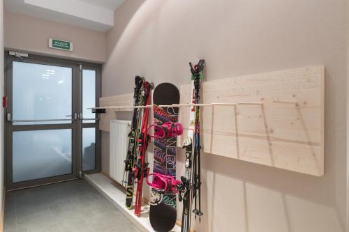 a room with skis hanging on a wall at Hotel Foluszowy Potok in Zakopane