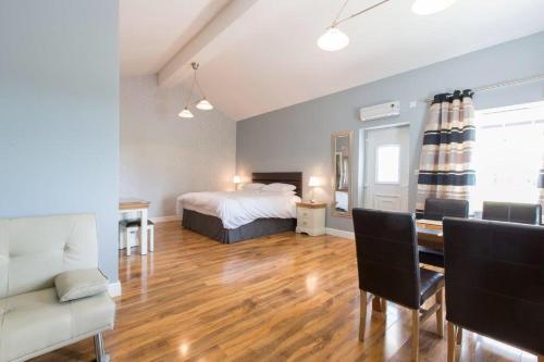a bedroom with a bed and a table and a couch at Silverstone Golf Club And Hotel in Silverstone