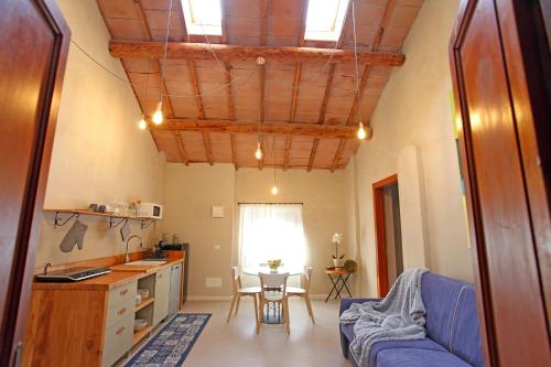 a living room with a blue couch and a table at Il Bozzolo Eco Boutique Apartments in Valeggio sul Mincio