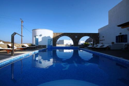 a swimming pool in front of a building at Vigla Hotel in Aegiali