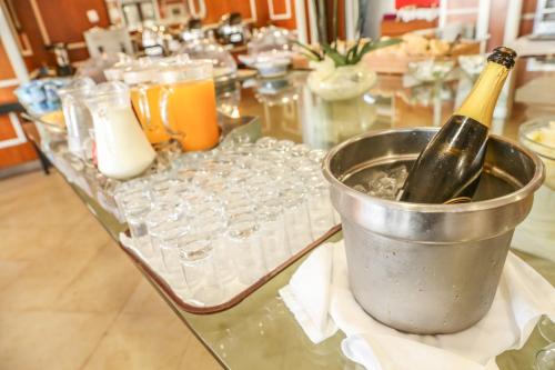 a bottle of champagne in a bucket on a table with glasses at Boa Vista Hotel & Spa - Adults Only in Albufeira