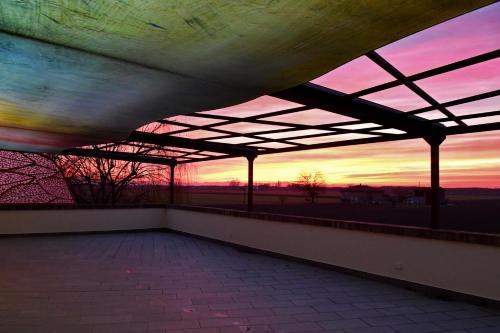a room with a view of a sunset from a roof at Il Murello in Fiorentina