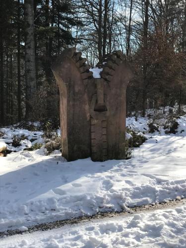a statue in the snow with snow on the ground at Chez Dina in Lutzelhouse