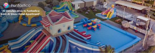 an aerial view of a water park with a water slide at Al Smou Hotel Apartments - MAHA HOSPITALITY GROUP in Ajman 