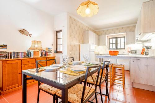 a dining room with a table and chairs in a kitchen at Altura Inn Cottage in Altura