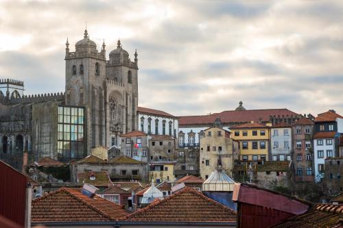 a large building with a clock tower on top of it at Oca Flores Hotel Boutique in Porto