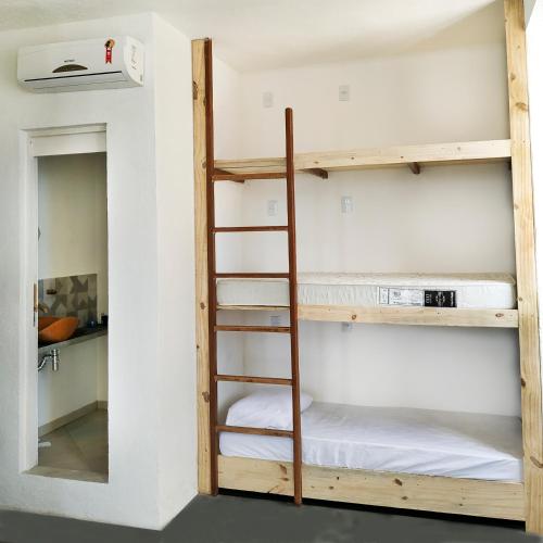 a room with two bunk beds and a ladder at Mar à Vista Hostel in Salvador