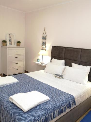 a bedroom with a large bed with two towels on it at Sonetos do Sado in Setúbal