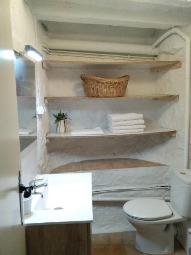 a bathroom with a white toilet and a sink at Casa Carlota in Cabó