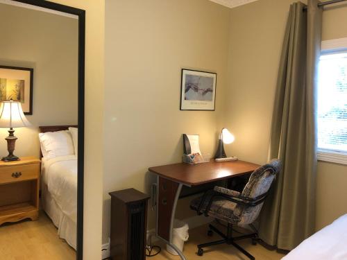 a bedroom with a desk and a bed and a mirror at Cozy Bedrooms Guest House in Vancouver