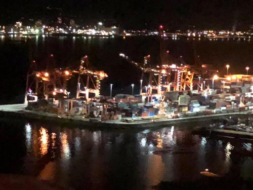 a large boat is docked in the water at night at Cozy Bedrooms Guest House in Vancouver