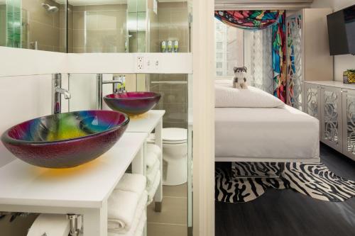 a bathroom with two sinks and a bed at Staypineapple, An Artful Hotel, Midtown New York in New York