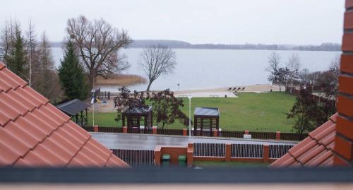 a view of a park and a body of water at Świat Jezior in Mikołajki