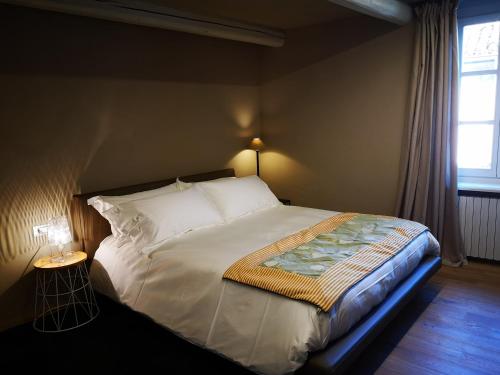 a large bed in a bedroom with a window at Luxury Langhe Loft in La Morra