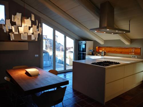 a kitchen with a table and a stove top oven at Luxury Langhe Loft in La Morra