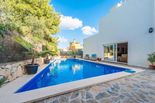 a swimming pool in the backyard of a house at VILLA CAN JAUME in Alcudia