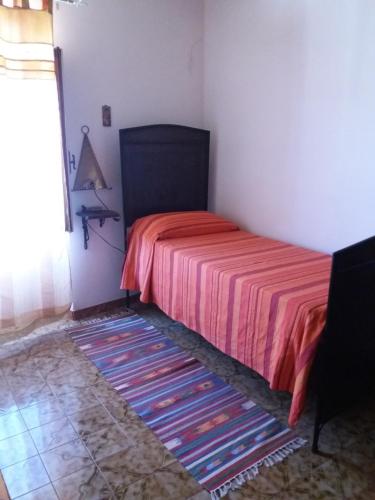 a bedroom with a bed with a red bedspread at Il Nespolo in Modolo