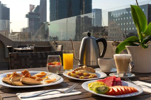a table with plates of breakfast food and drinks at Eurostars Zona Rosa Suites in Mexico City