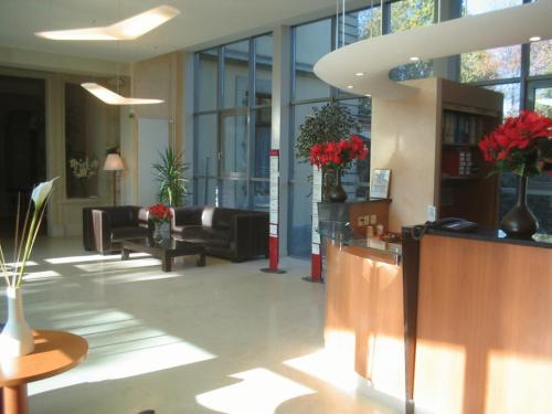 a lobby with couches and chairs in a building at Le Cénacle in Geneva