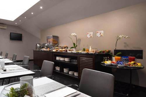 restauracja ze stołami i krzesłami, na ladzie znajduje się jedzenie w obiekcie Exe Suites Reforma w mieście Meksyk