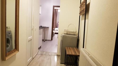 a hallway leading to a laundry room with a washer and dryer at Cozy Apartment in Old Tbilisi in Tbilisi City