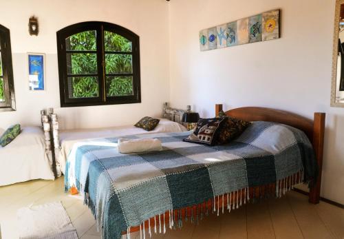 מיטה או מיטות בחדר ב-Pousada Bela Casa Geribá