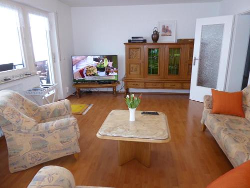 a living room with a couch and a coffee table at Schwarzwald-Ferienwohnungen Begert in Baiersbronn