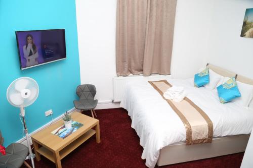 バーミンガムにあるBirmingham Central Station Apartment (Studio 3)のベッド2台、薄型テレビが備わるホテルルームです。
