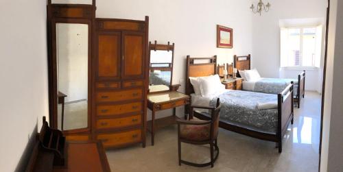 a bedroom with a bed and a desk and a dresser at Viola Borgia in Florence