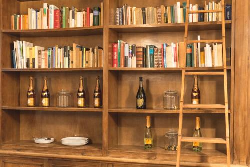 a book shelf filled with bottles and books at Fourooms - Bari Sparano in Bari