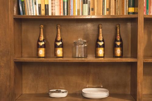 a shelf with five bottles of wine on it at Fourooms - Bari Sparano in Bari
