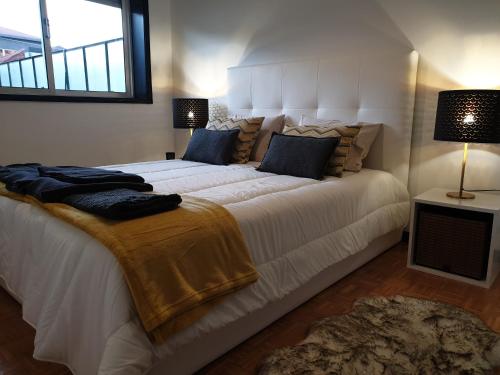 a large white bed in a room with a window at Invicta Flats - Oporto in Porto