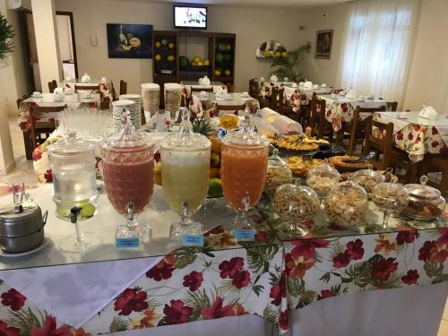 a table with many different colored drinks in glasses at Hotel Marlin Azul in Iriri